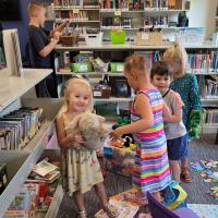 Toddlers examining books at the Maggie Osgood Library